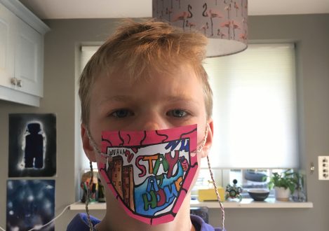 child wearing a paper mask