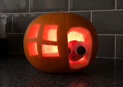 A carving of a baby pumpkin inside a house