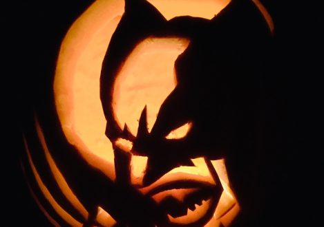 A pumpkin carving with Wolverine carved into the center