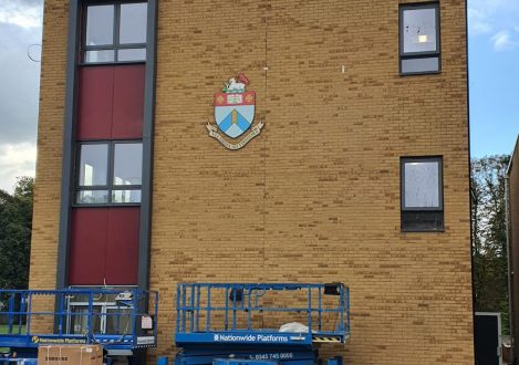 The Halliford Logo being added to the wall