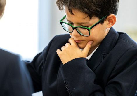 Student thinking about his next move as he plays chess