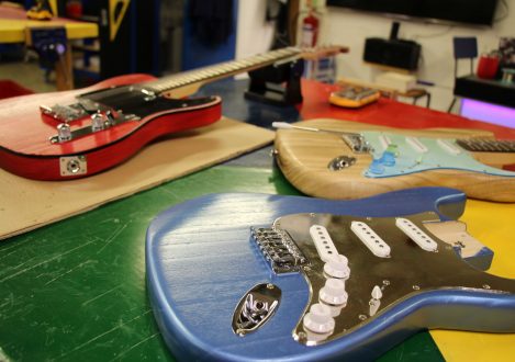 3 guitars on a table