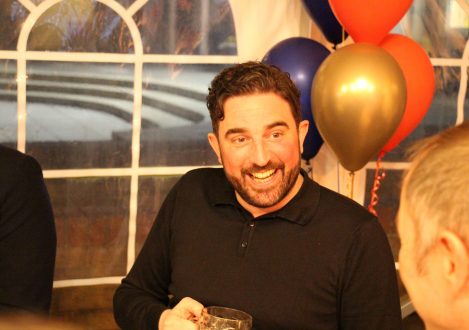 man infront of balloons