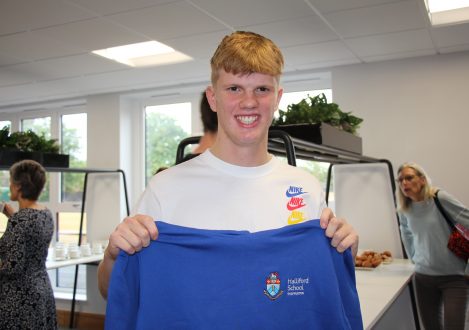 pupil holding up his school jumper
