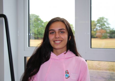girl in pink hoodie smiling