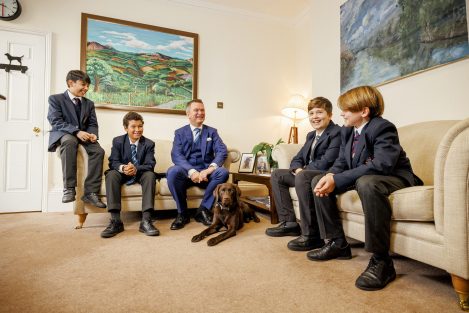 children and teacher sat on sofas