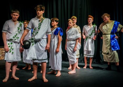 children dress in robes and leaves