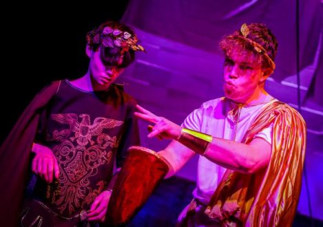 two boys wearing leaf crowns and robes