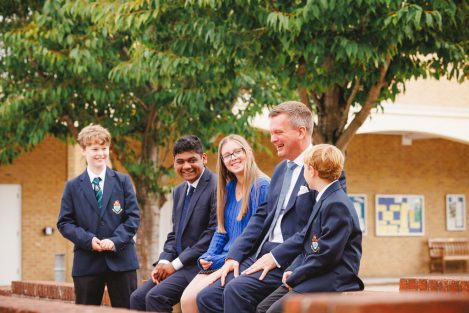 students laughing around the teacher