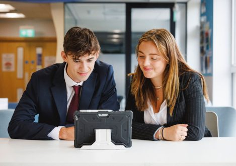 2 students using an iPad