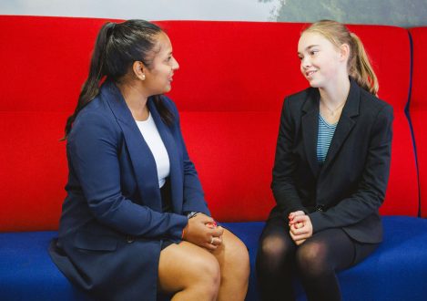 2 girls having a conversation on sofas