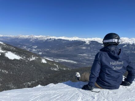 student sat on the snow