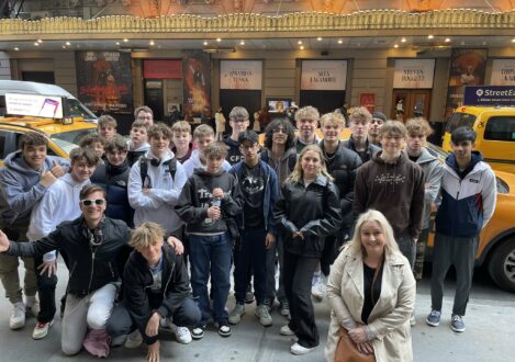 group of students outside a theatre