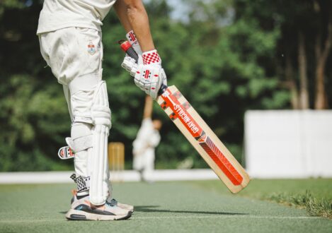 student holding cricket bat