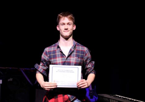 student holding a certificate
