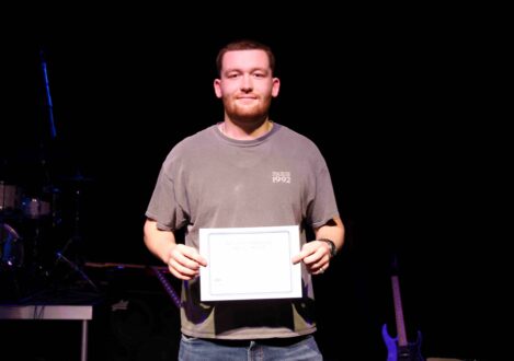 student holding a certificate