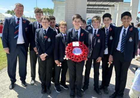 students holding poppy wreath
