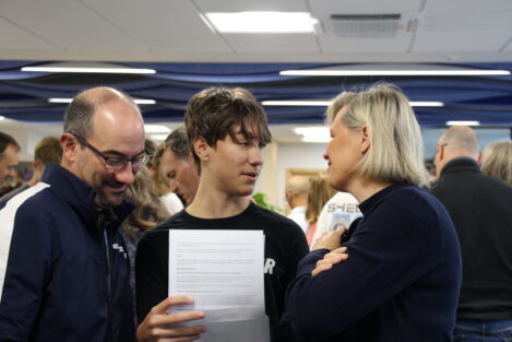 student discussing exam results with parents