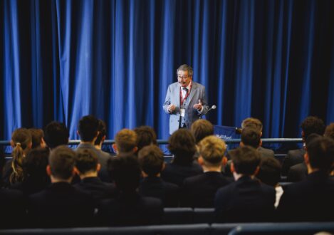 man speaking to a group of people